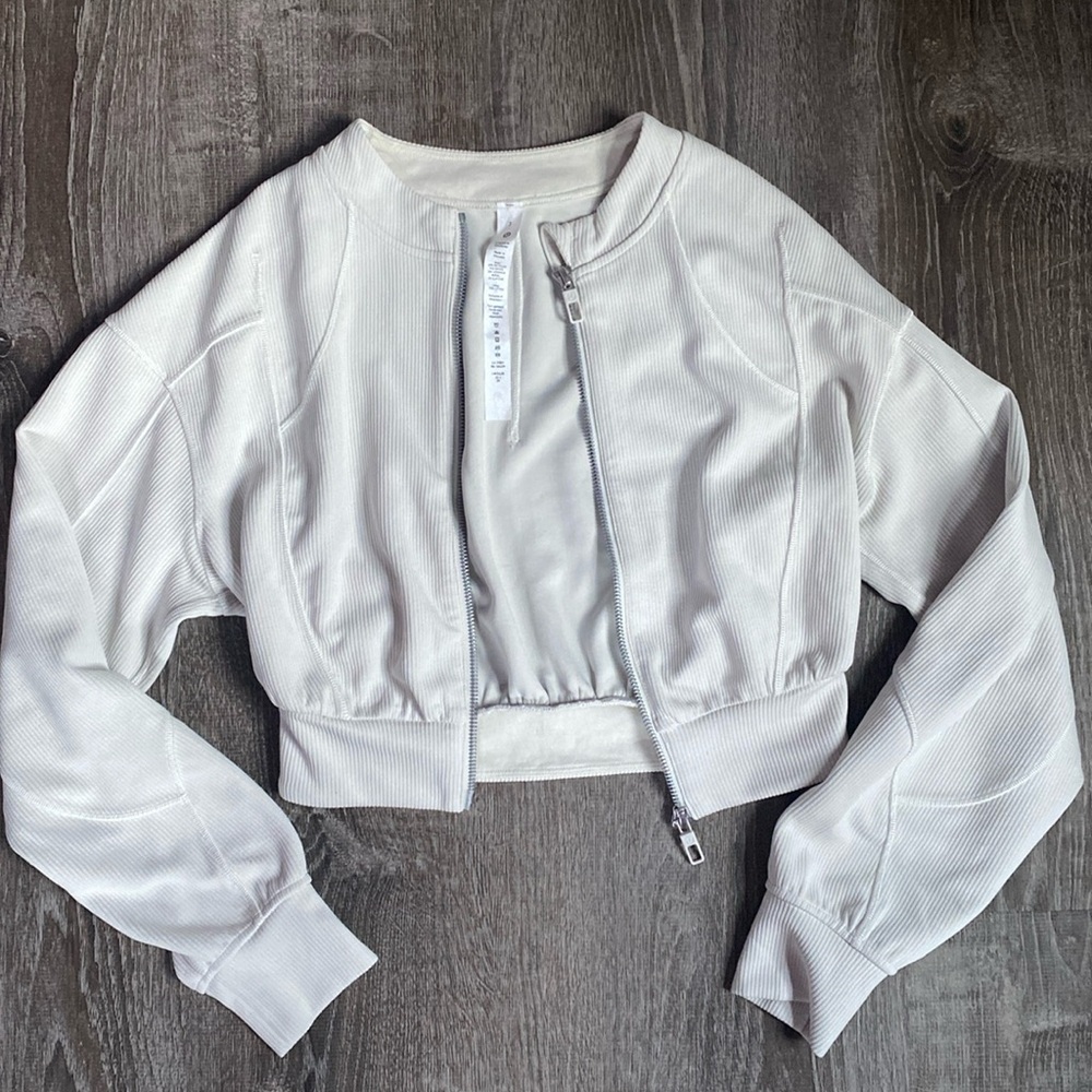 This is an off white jacket from lululemon, in a size 2